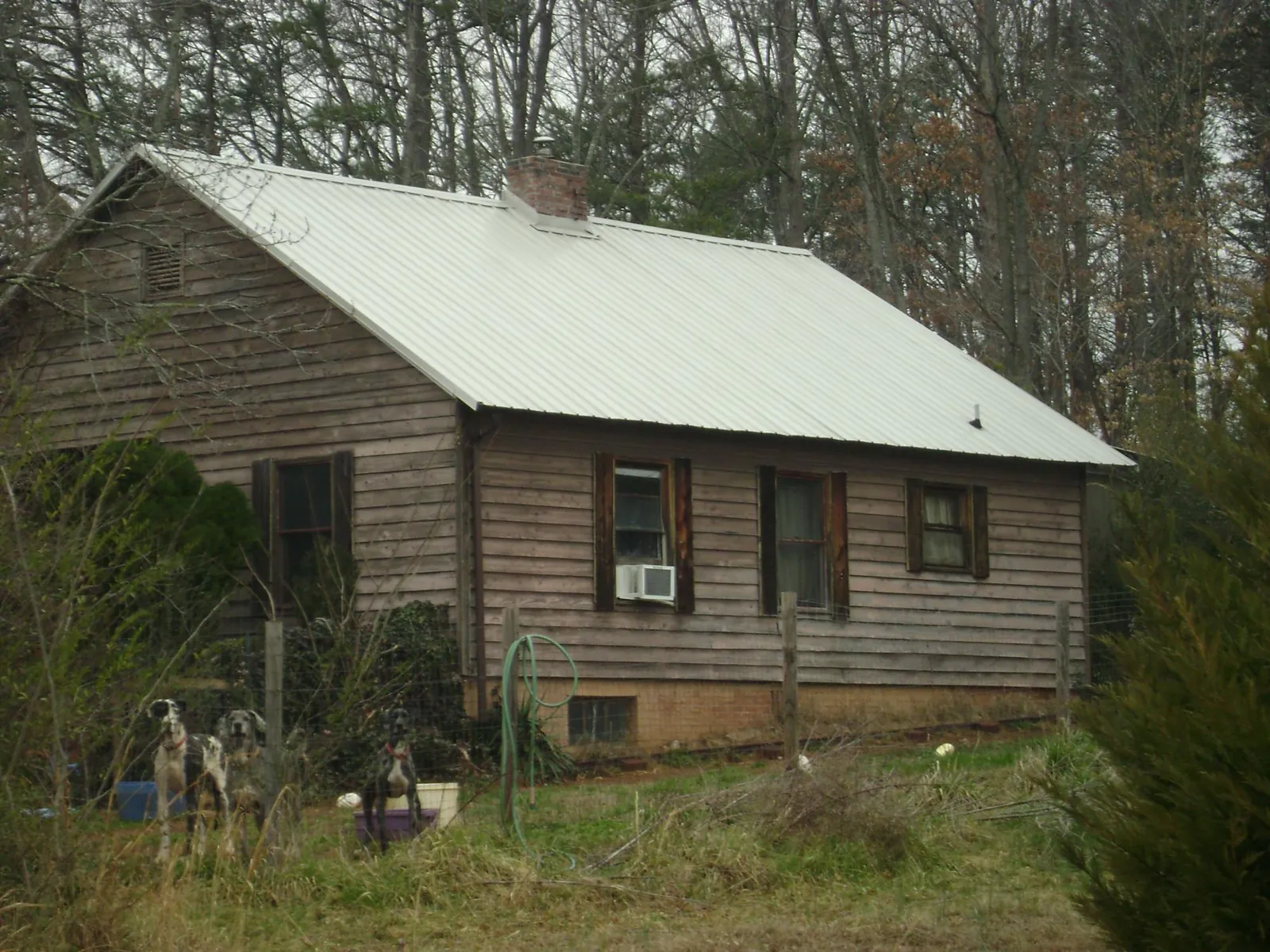 White metal roof on an old wood sided farmhouse, from a Metal Roof Installation job in Jenners